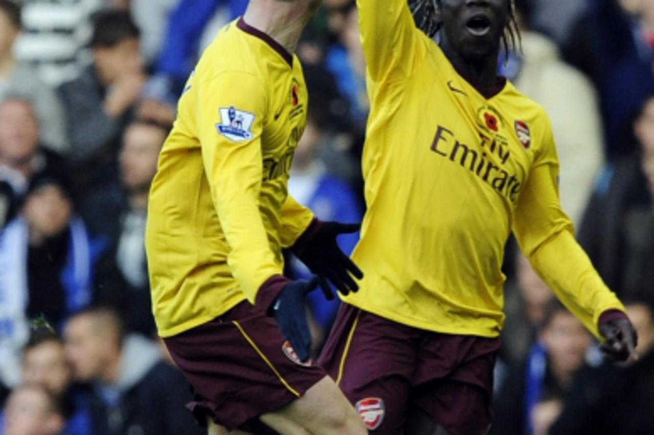\'Arsenal\'s Bacary Sagna (R) celebrates scoring against Everton with Sebastien Squillaci during their English Premier League soccer match in Liverpool, northern England November 14, 2010. REUTERS/Nig