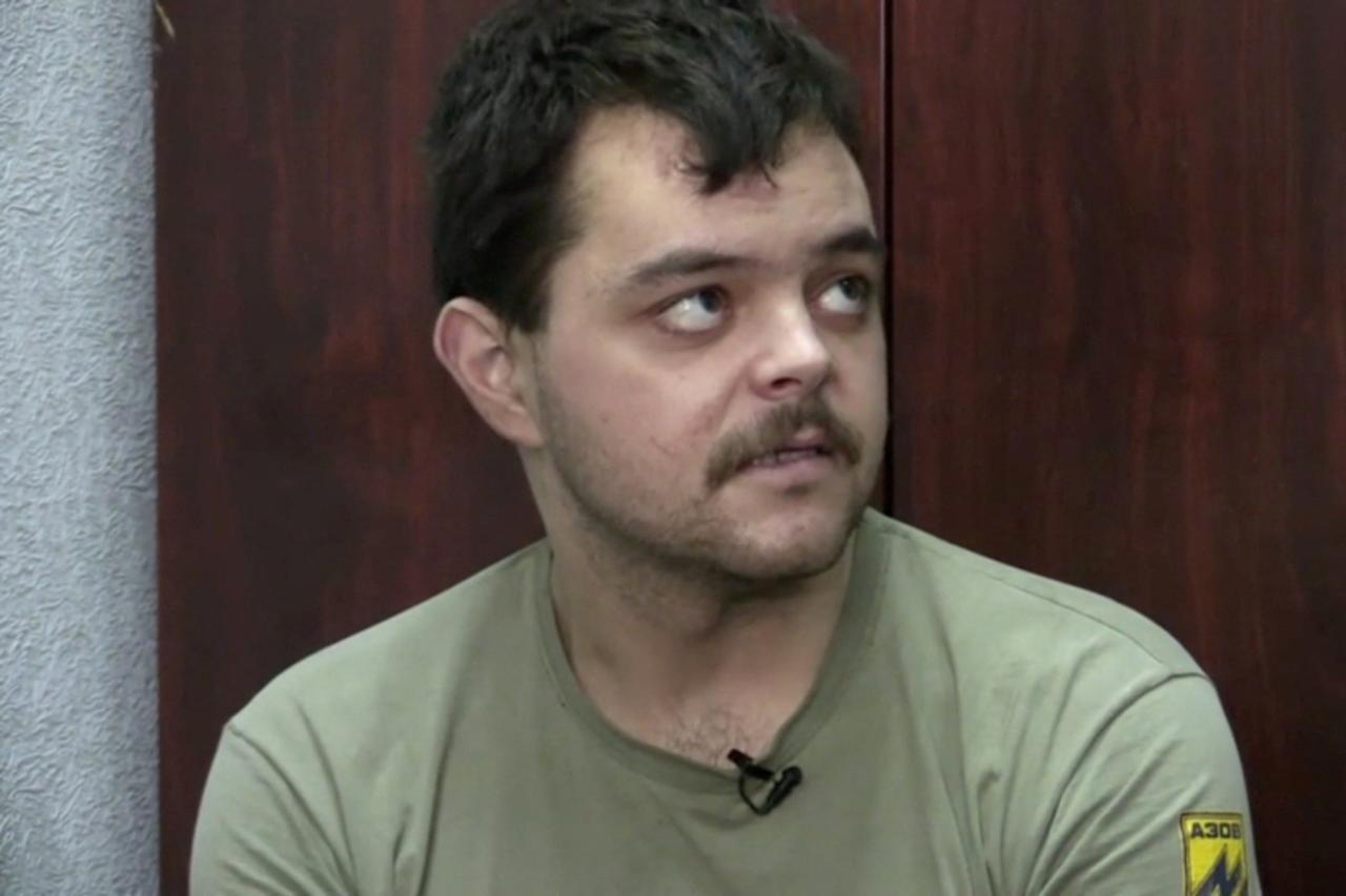 A still image from Russian state TV footage that it said shows a captured British fighter at an unknown location