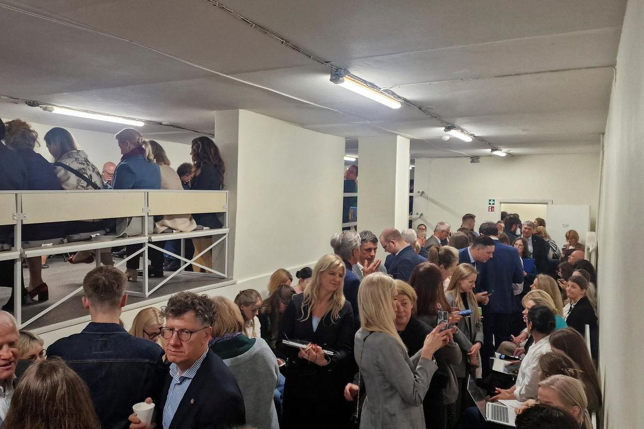 People gather inside a shelter at the Lithuanian parliament after an 'air danger' warning, in Vilnius