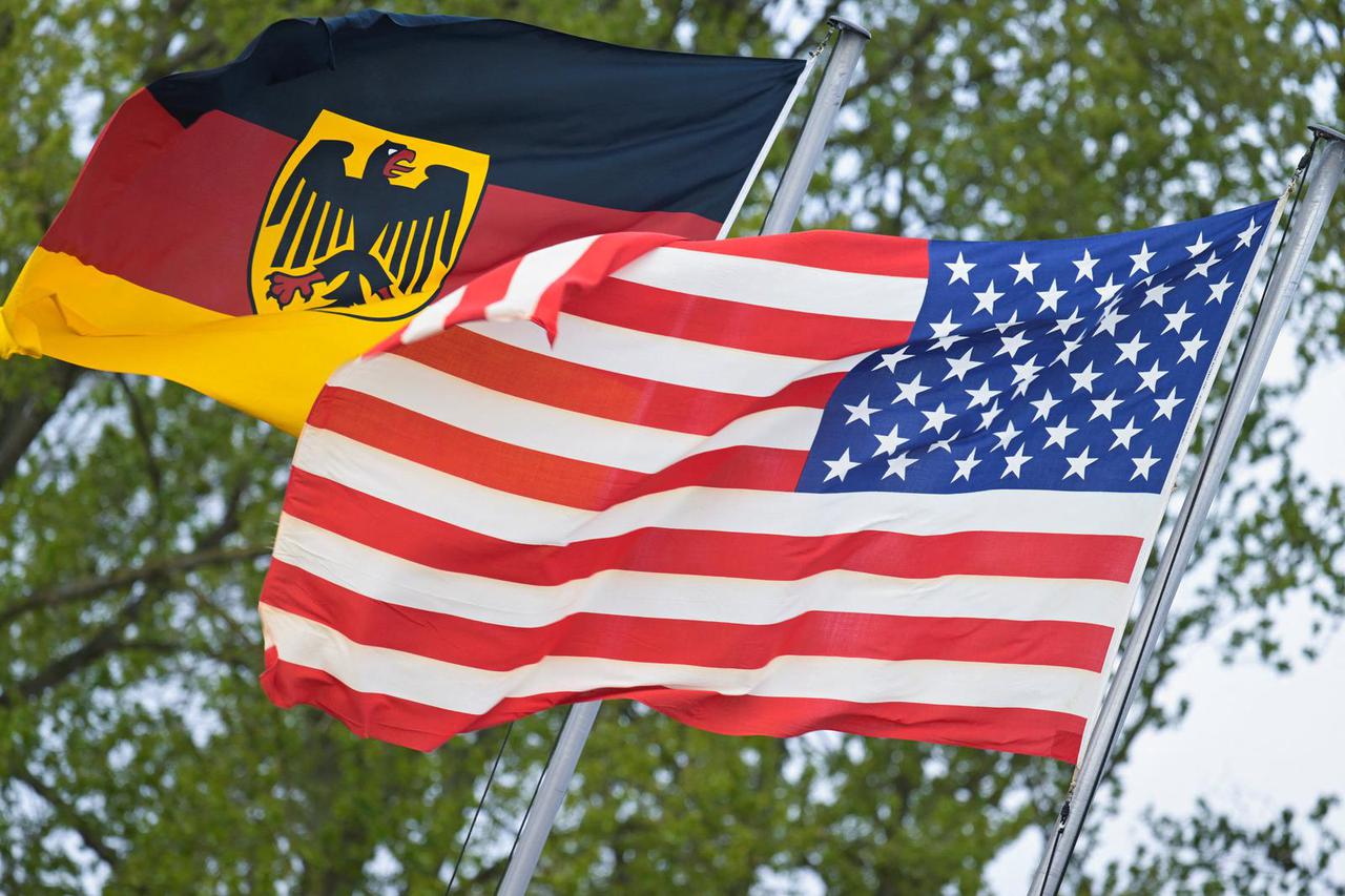 The German flag featuring the Federal Eagle and the U.S. flag are pictured at the German Navy base in Kiel