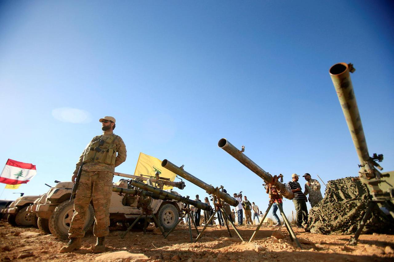 FILE PHOTO: A Hezbollah fighter stands in front of anti-tank artillery at Juroud Arsal