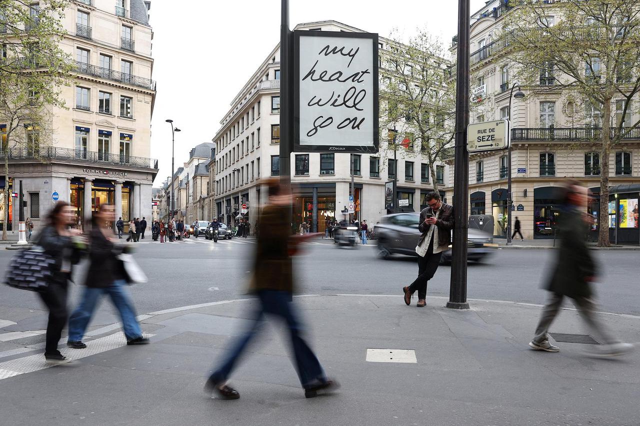 Song titles by singer Celine Dion on posters in the streets of Paris