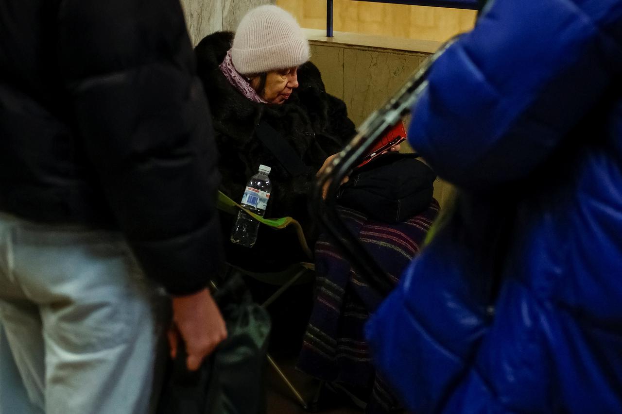 People take shelter inside a metro station during a Russian military strike in Kyiv