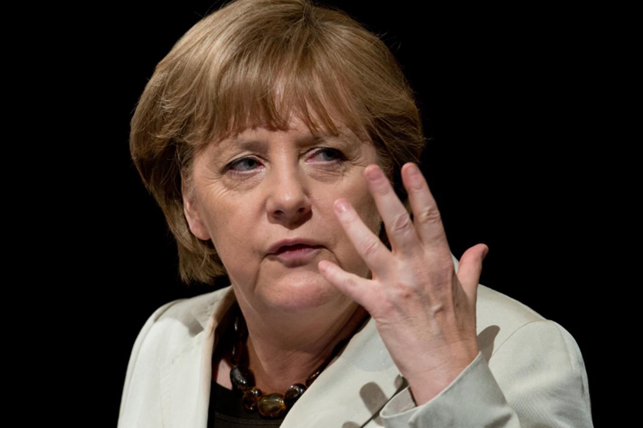 'epa03268035 German Chancellor Angela Merkel speaks at the 104th state party meeting of the Hesse CDU in Darmstadt, Germany, 16 June 2012. More than 300 delegates were scheduled to elect the new party