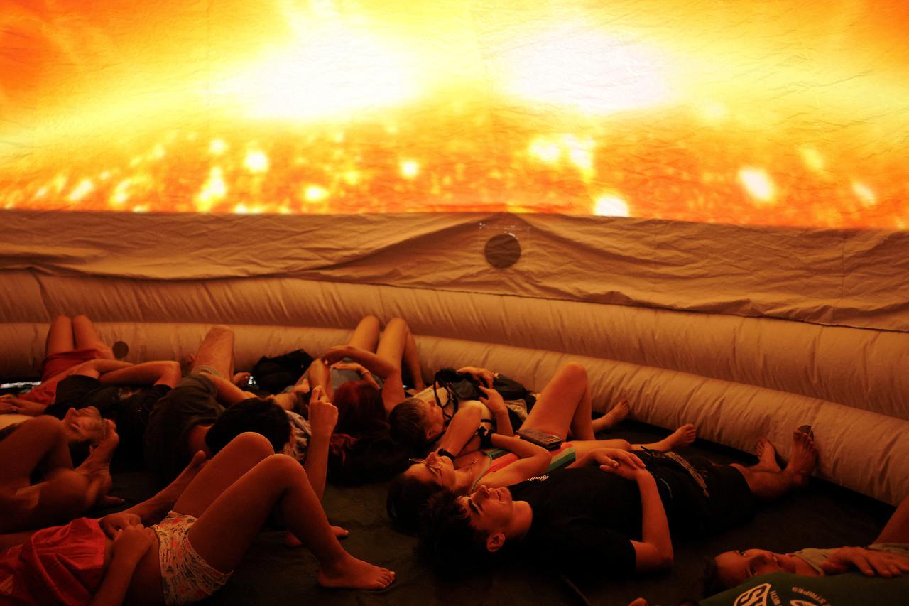 People attend an eclipse watch party on the day of a total solar eclipse in Buitrago del Lozoya