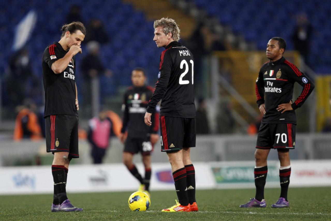 'AC Milan\'s Zlatan Ibrahimovic (L), Maxi Lopez (C) and Robinho (R) react after SS Lazio\'s Rocchi (not pictured) scored during their Italian Serie A soccer match at the Olympic stadium in Rome Februa