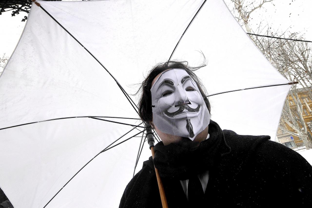 'A protester wearing an Anonymous Guy Fawkes mask takes part in a demonstration against controversial Anti-Counterfeiting Trade Agreement (ACTA) as part of an international day of action against the i