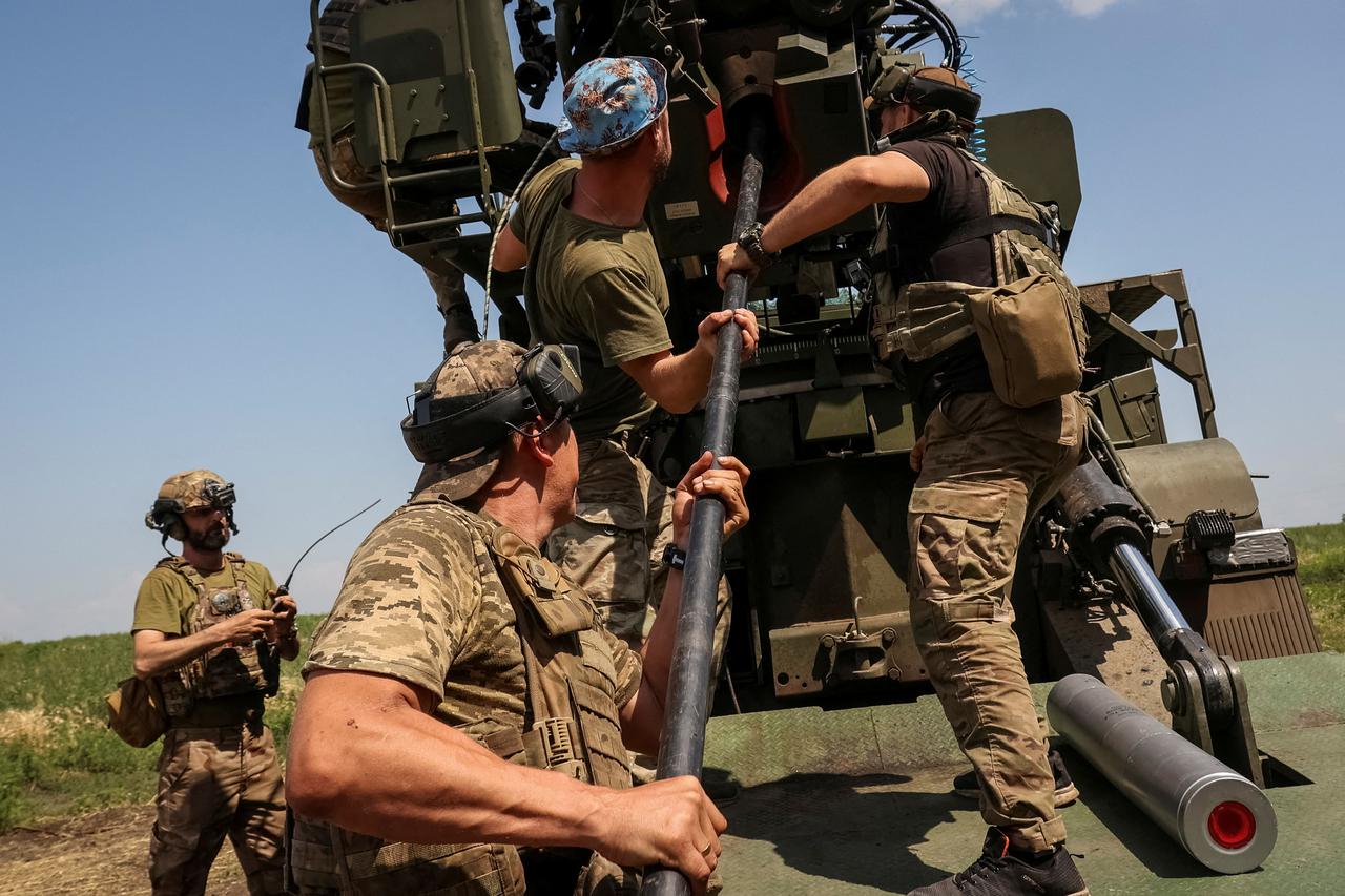 FILE PHOTO: Ukrainian servicemen prepare to fire a 2S22 Bohdana self-propelled howitzer towards Russian troops at a position near the city of Bakhmut