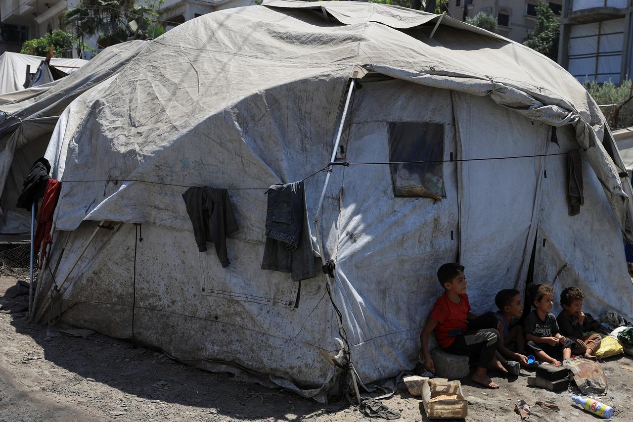 Palestinians displaced by the Israeli military offensive take shelter in tents, in Gaza City