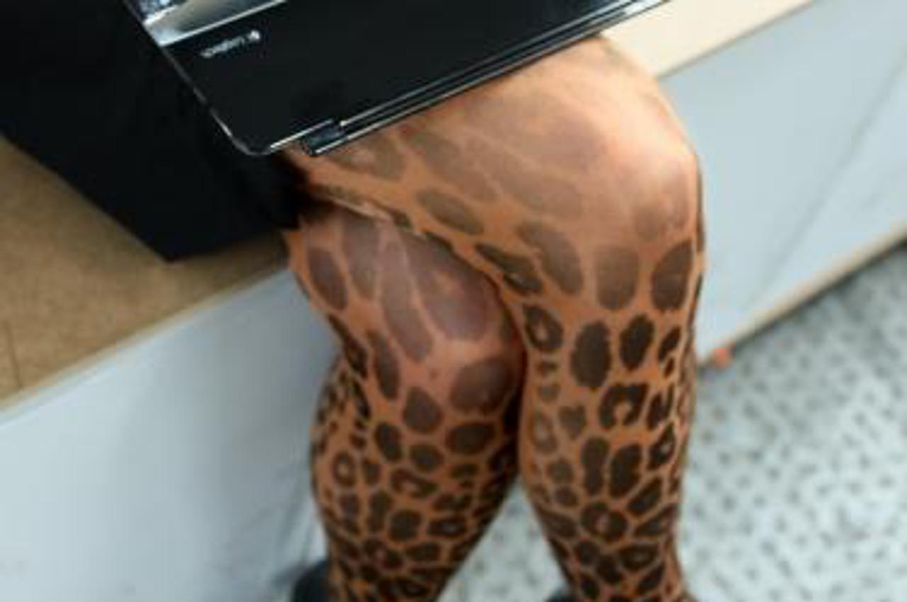 'A visitor of the internet conference Re:publica sits with her laptops on the platform in Berlin, Germany, 08 May 2013. Re:publica 13, one of the biggest conferences about social media and digital soc