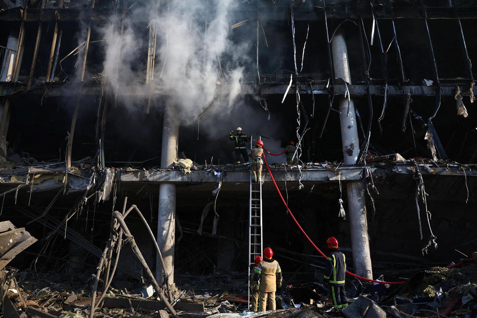 Firefighters work at the site of a bombing at a shopping center as Russia's invasion of Ukraine continues, in Kyiv, Ukraine March 21, 2022. REUTERS/Marko Djurica Photo: MARKO DJURICA/REUTERS