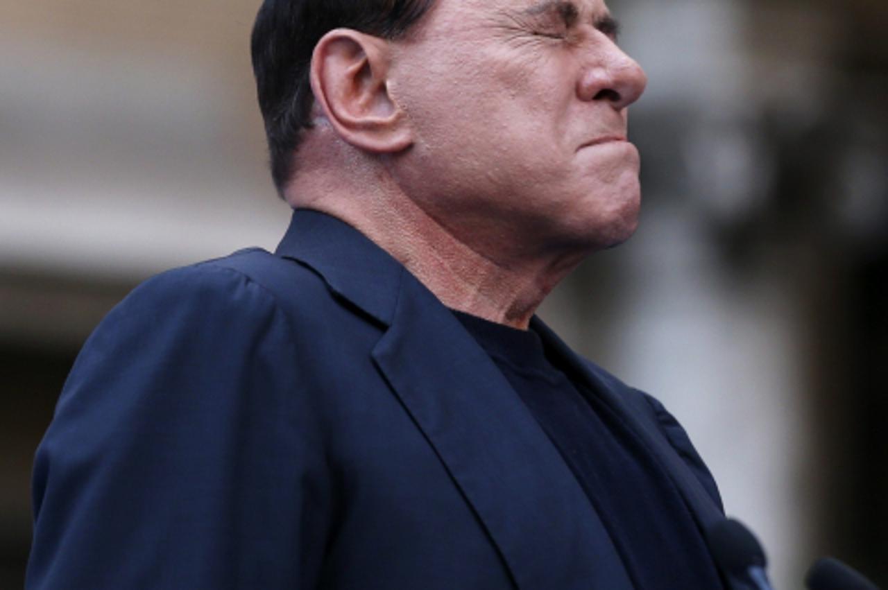 'Former Italian Prime Minister Silvio Berlusconi closes his eyes in a gesture to supporters during a rally to protest his tax fraud conviction, outside his palace in central Rome August 4, 2013. Tensi
