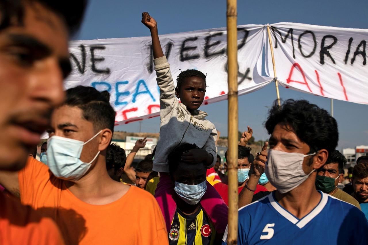 Refugees and migrants from the destroyed camp of Moria clash with the police on the island of Lesbos