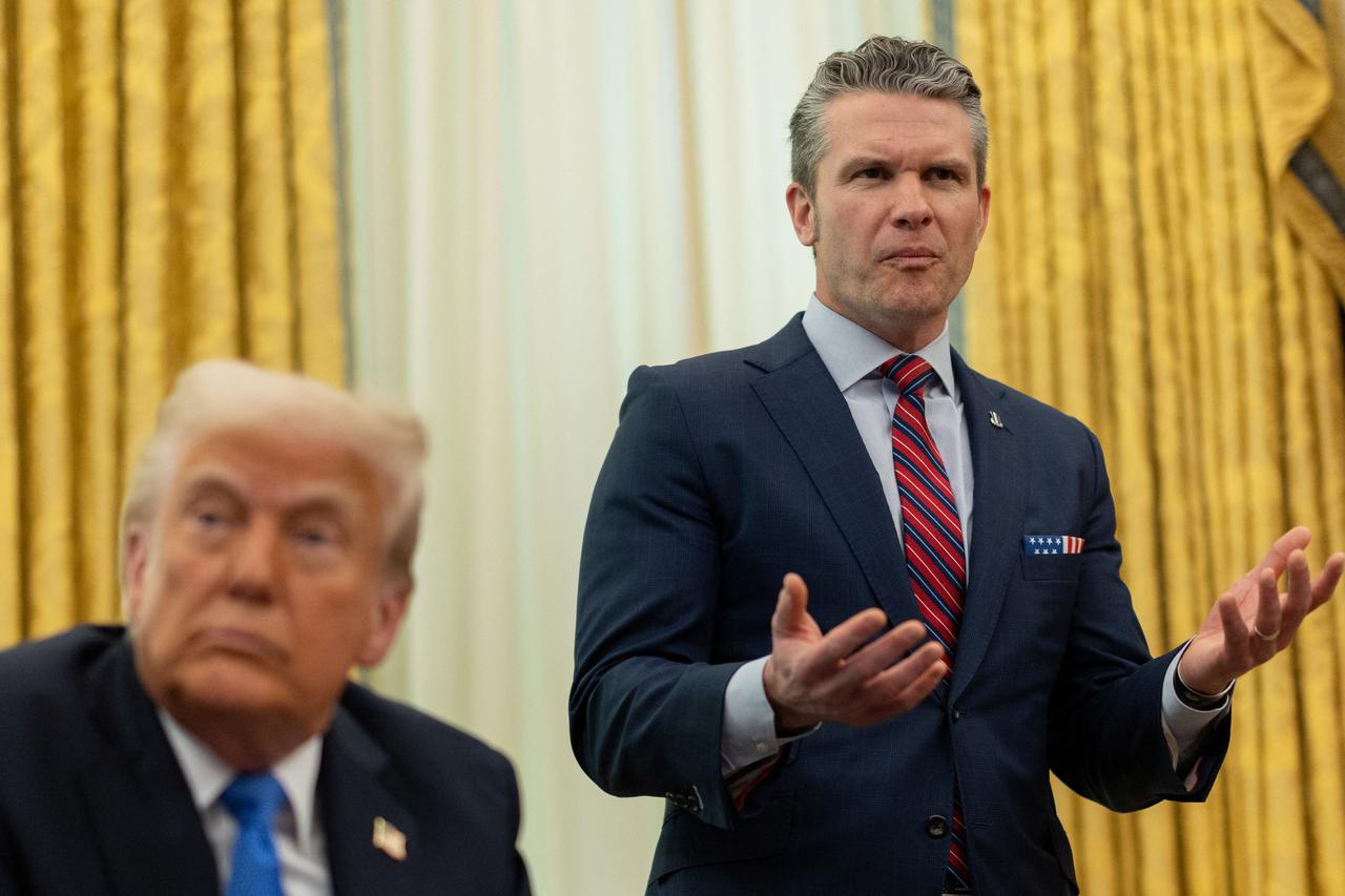 U.S. Defense Secretary Pete Hegseth speaks next to President Donald Trump, in the Oval Office at the White House, in Washington, D.C.