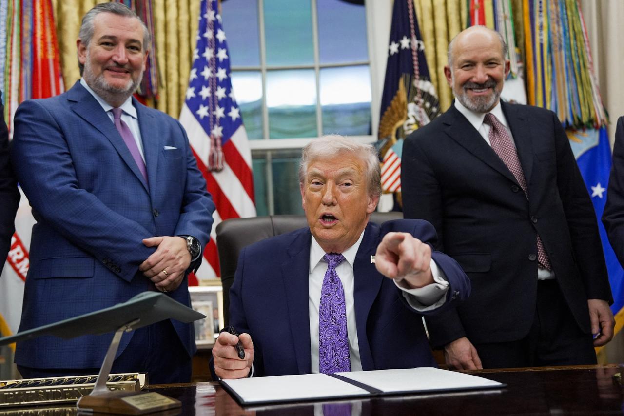 U.S. President Donald Trump signs an executive order in the Oval Office of the White House