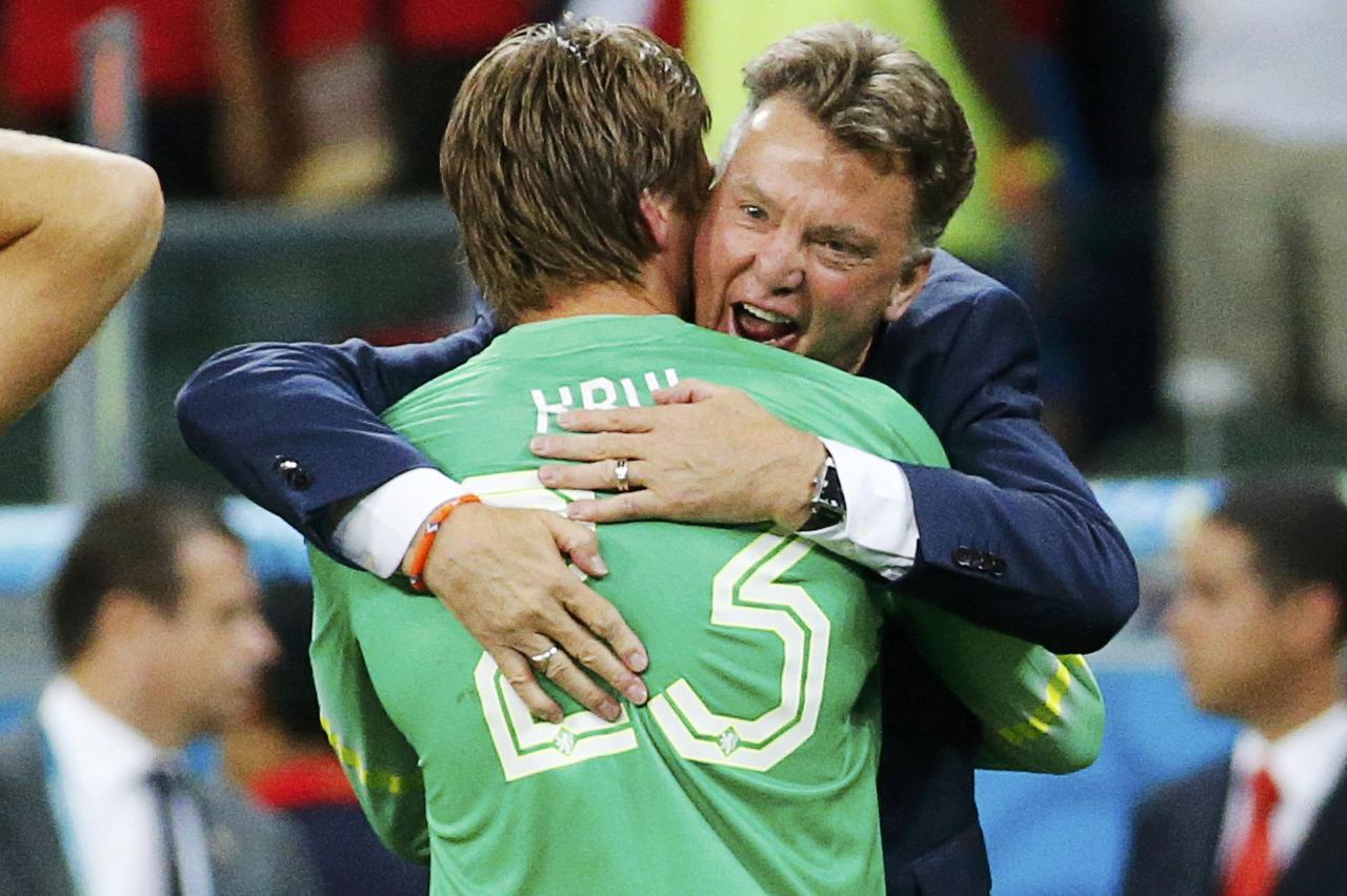Tim Krul of the Netherlands is hugged by coach Louis van Gaal after making the match winning penalty save in their shootout against Costa Rica during their 2014 World Cup quarter-finals at the Fonte Nova arena in Salvador July 5, 2014.  REUTERS/Sergio Mor