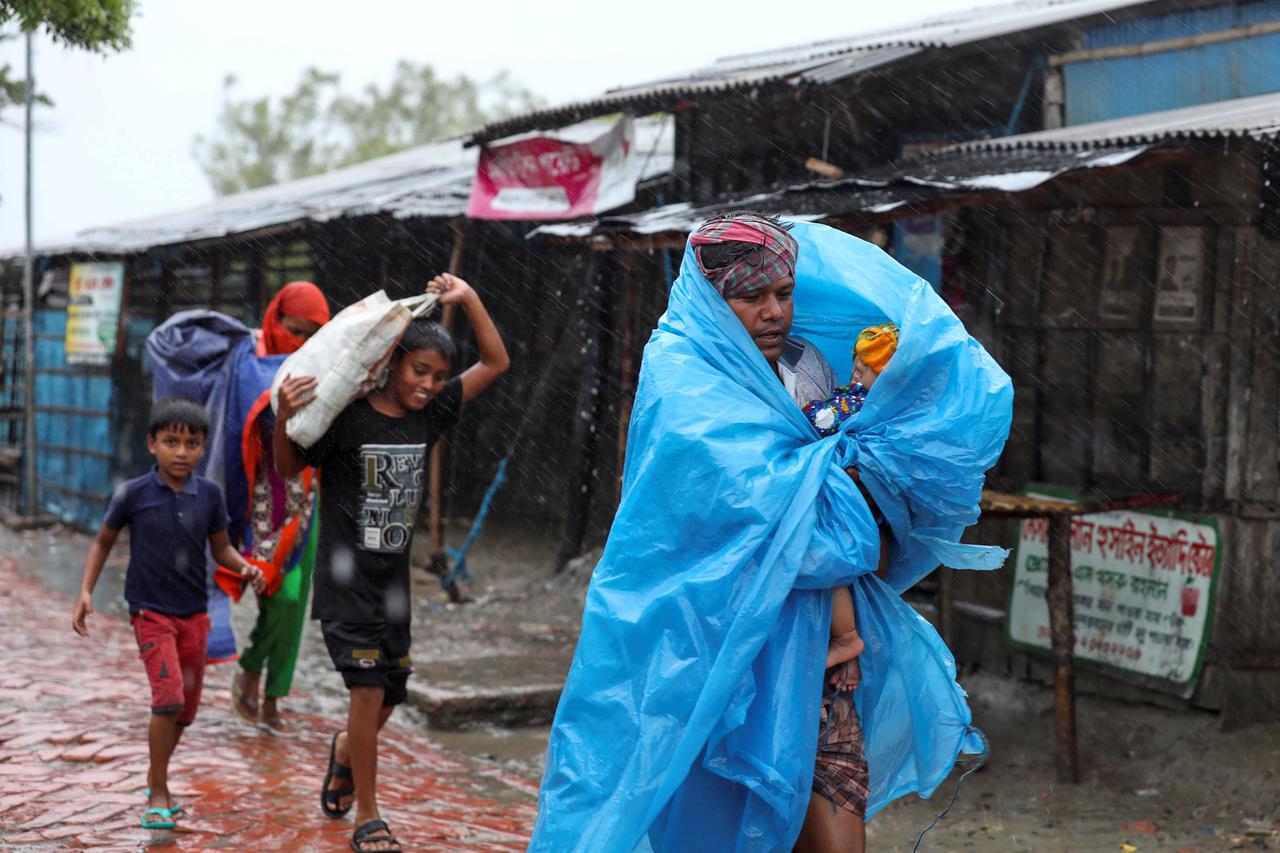 People make their way to a safer place before the cyclone Amphan makes its landfall in Gabura outskirts of Satkhira district