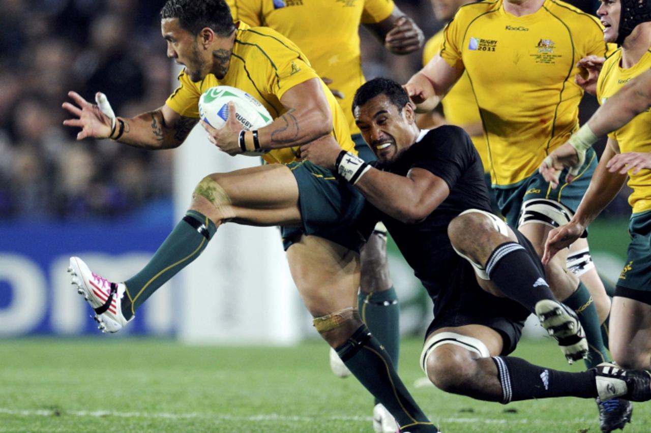 'New Zealand All Blacks\' Jerome Kaino (L) tackles Australia Wallabies\' Digby Ioane during their Rugby World Cup semi-final match at Eden Park in Auckland October 16, 2011. REUTERS/Anthony Phelps (NE