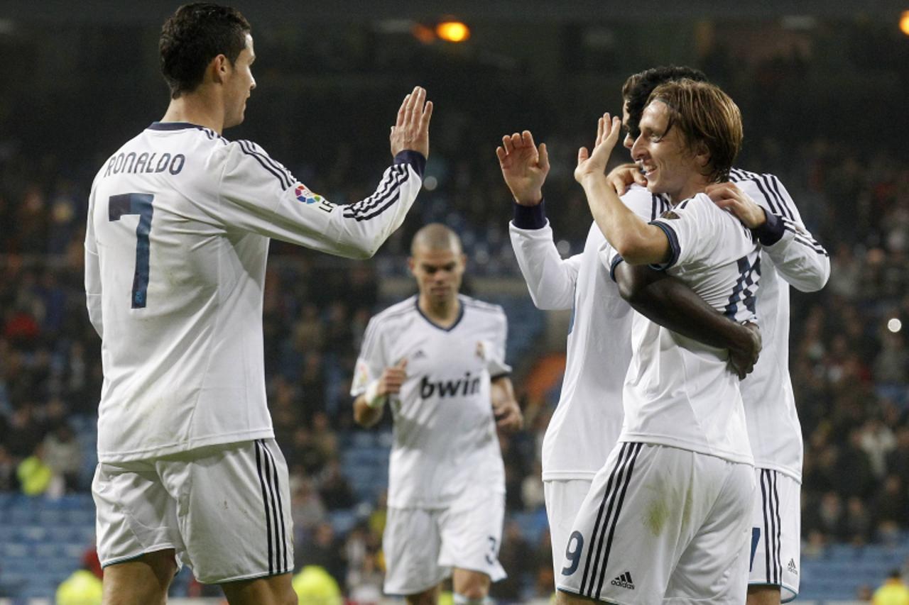 'Real Madrid's Cristiano Ronaldo (L) congratulates Luka Modric for his goal against Real Zaragoza during their Spanish first division soccer match at Santiago Bernabeu stadium in Madrid November 3, 2