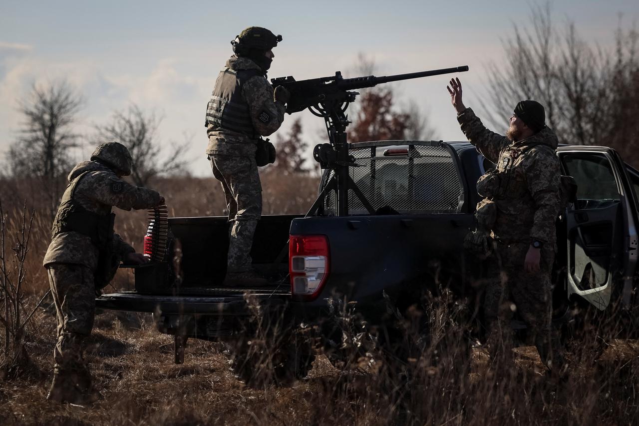 A Ukrainian serviceman from an air defence unit mans a Turkish-made Browning machine gun, near Kyiv