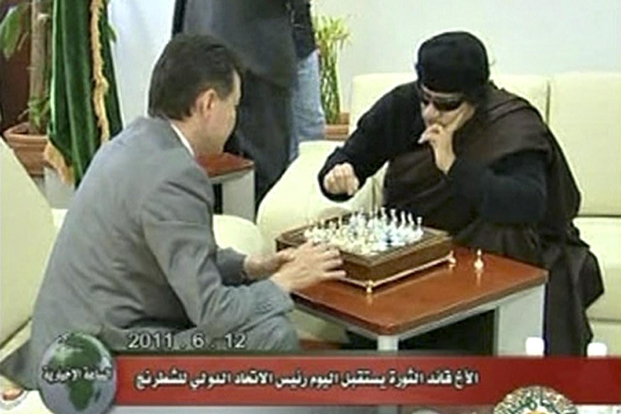 'Libyan leader Muammar Gaddafi plays chess with Kirsan Ilyumzhinov, the president of the international chess federation, in Tripoli on June 12, 2011 in this still image taken from video broadcast on L