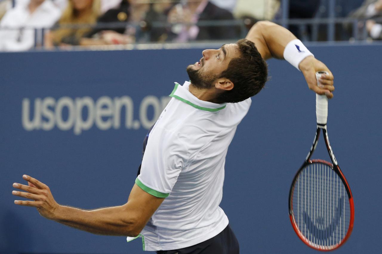 Marin Cilic of Croatia serves to Kei Nishikori of Japan during their men's singles final match at the 2014 U.S. Open tennis tournament in New York, September 8, 2014.           REUTERS/Ray Stubblebine (UNITED STATES  - Tags: SPORT TENNIS)