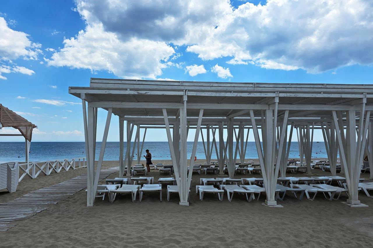 A woman walks at the beach in Yevpatoriya
