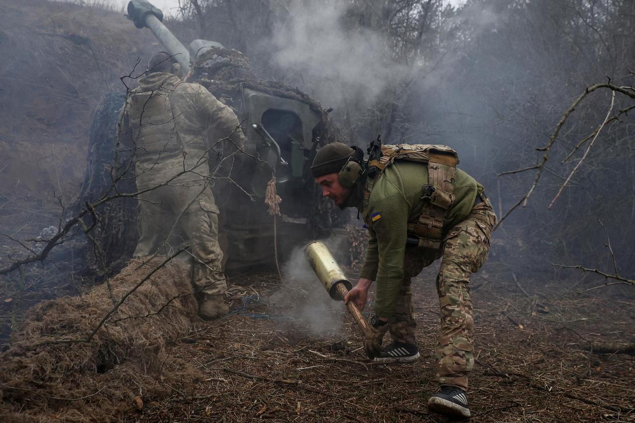 Ukrainian serviceman fire a D-30 howitzer towards Russian troops at a position in a front line in Kherson region