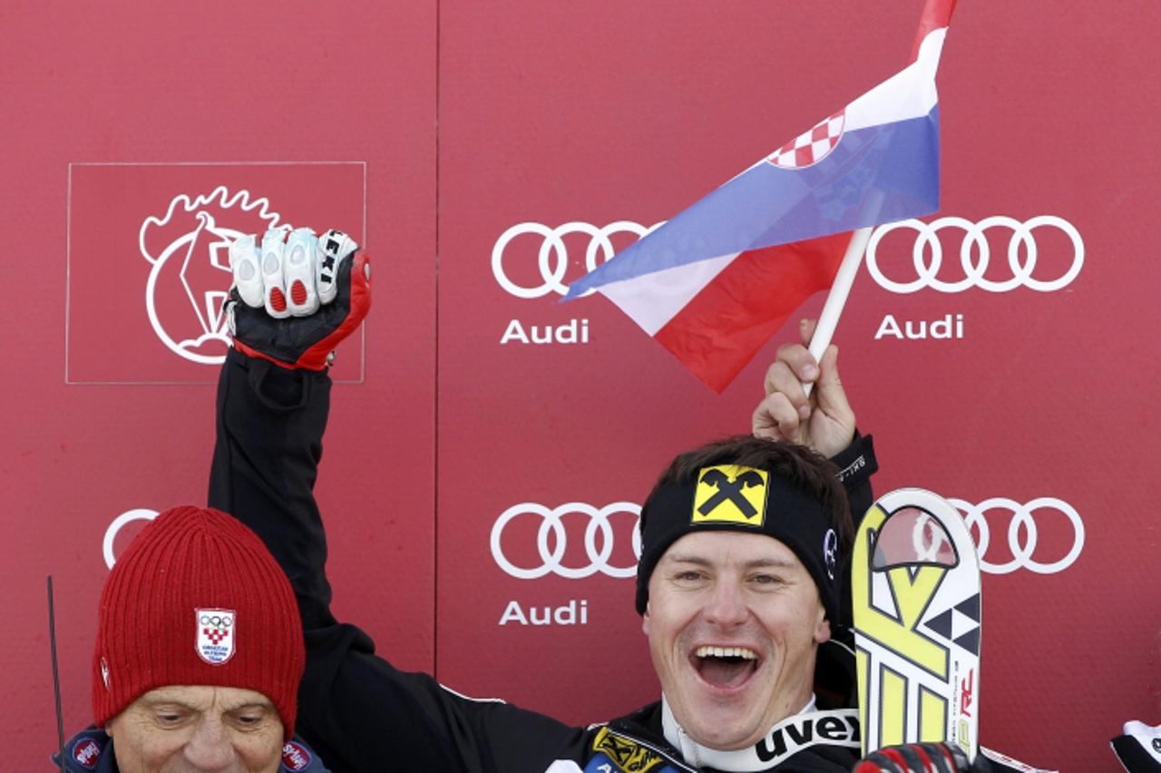 \'Ivica Kostelic of Croatia stands next to his father Ante Kostelic (L) as he celebrates winning the men\'s super-G race at the Alpine Skiing World Cup on Hahnnenkamm mountain in Kitzbuehel January 21