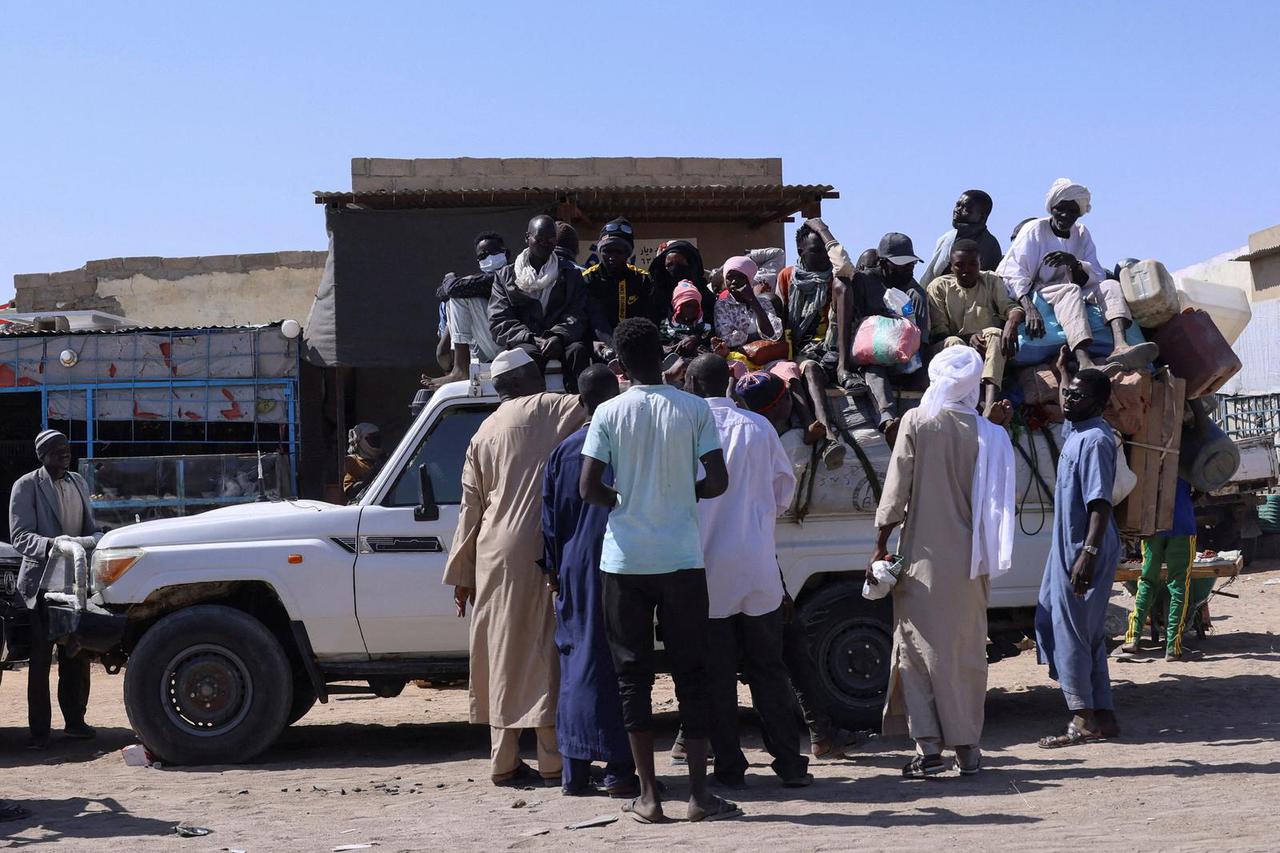 FILE PHOTO: People prepare to travel about 250 km south to Adre, on the Chad-Sudan border, at a transport station in Tine