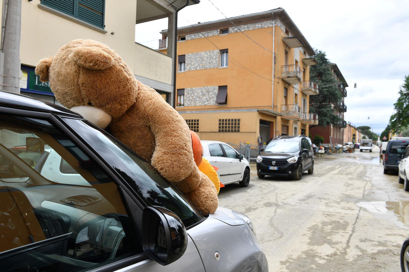 A teddy bear toy is seen on a car after heavy rains hit Italy's Emilia Romagna region, in Castel Bolognese, Italy, May 18, 2023. REUTERS/Jennifer Lorenzini Photo: JENNIFER LORENZINI/REUTERS