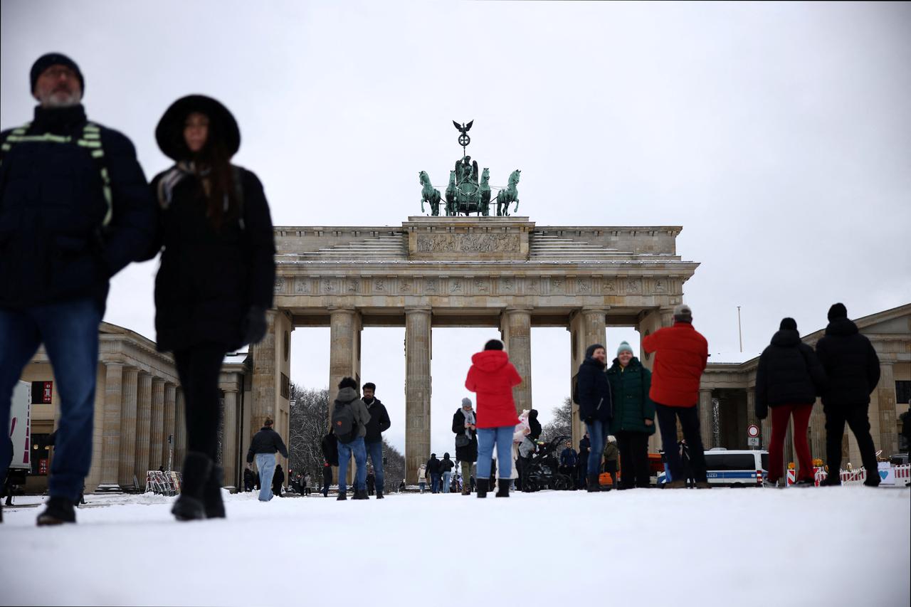 People walk in the snow at Brandenburg Gate in Berlin