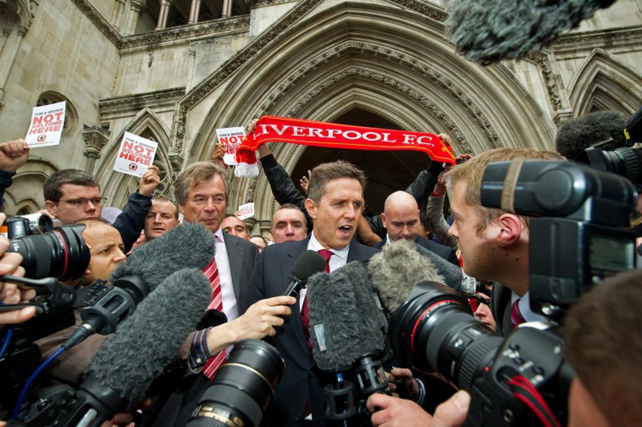 'Liverpool Football Club\'s Chairman, Martin Broughton (L), Director Ian Ayre (centre L) and Managing Director, Christian Purslow (C), address the media as they leave the High Court in central London 