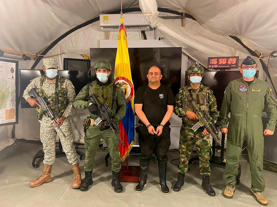 Dairo Antonio Usuga David, alias "Otoniel", top leader of the Gulf clan, poses for a photo escorted by Colombian military soldiers after being captured, in Necocli