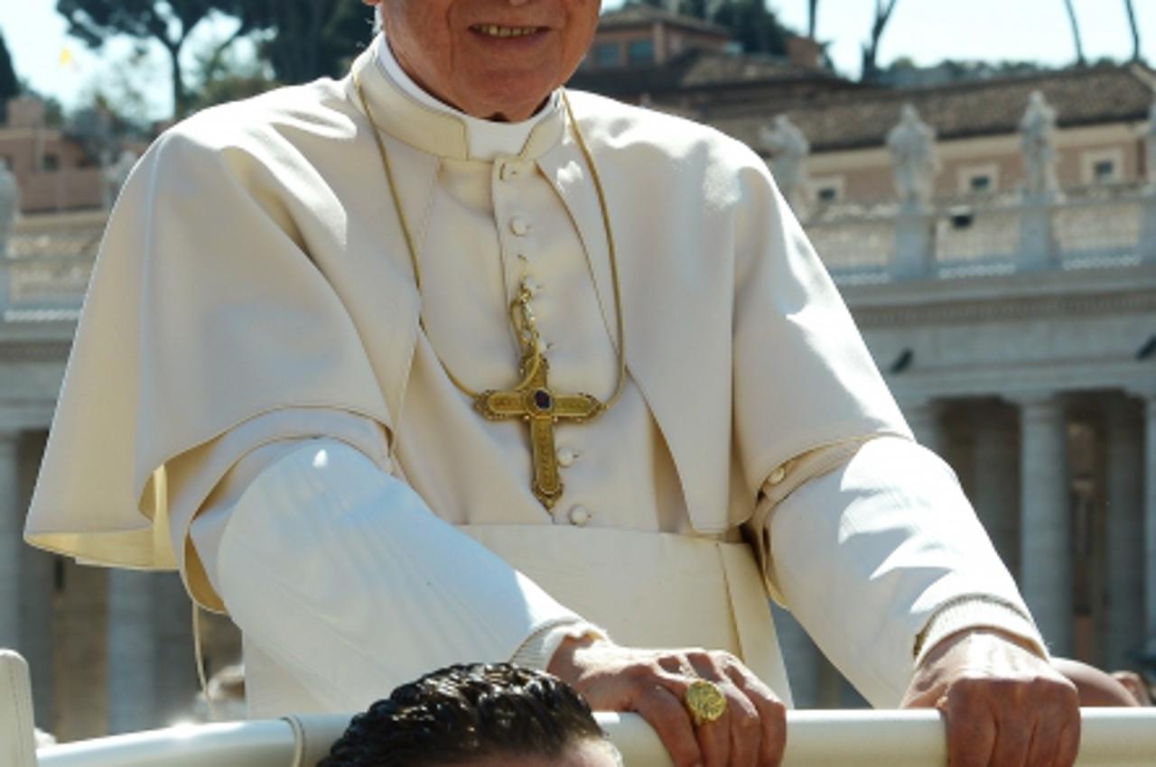'(FILES) Paolo Gabriele (Bottom), the pope\'s butler, sits in the popemobilenext to Pope Benedict XVI as they arrive in St. Petr\'s square on April 18, 2012 for the pope\'s weekly general audience. Va