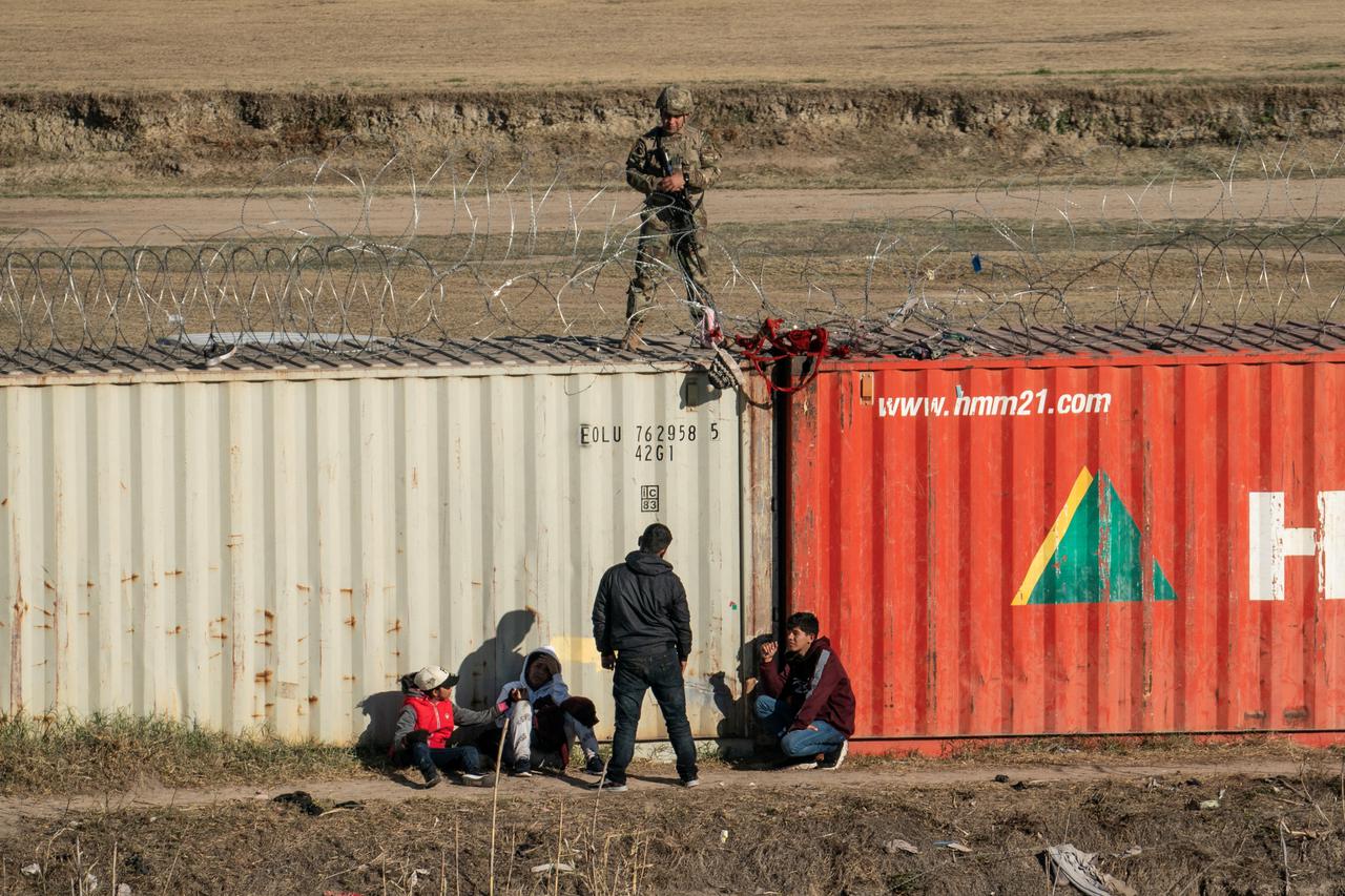 Migrants cross the border into Texas from Mexico