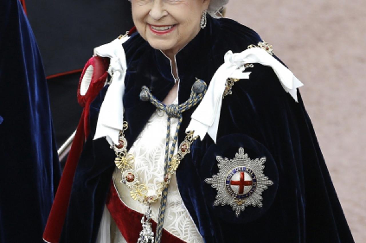 'Britain's Queen Elizabeth walks in procession as she attends the annual Order of the Garter Service at St George's Chapel at Windsor Castle in Windsor, southern England June 17, 2013. REUTERS/Kirst