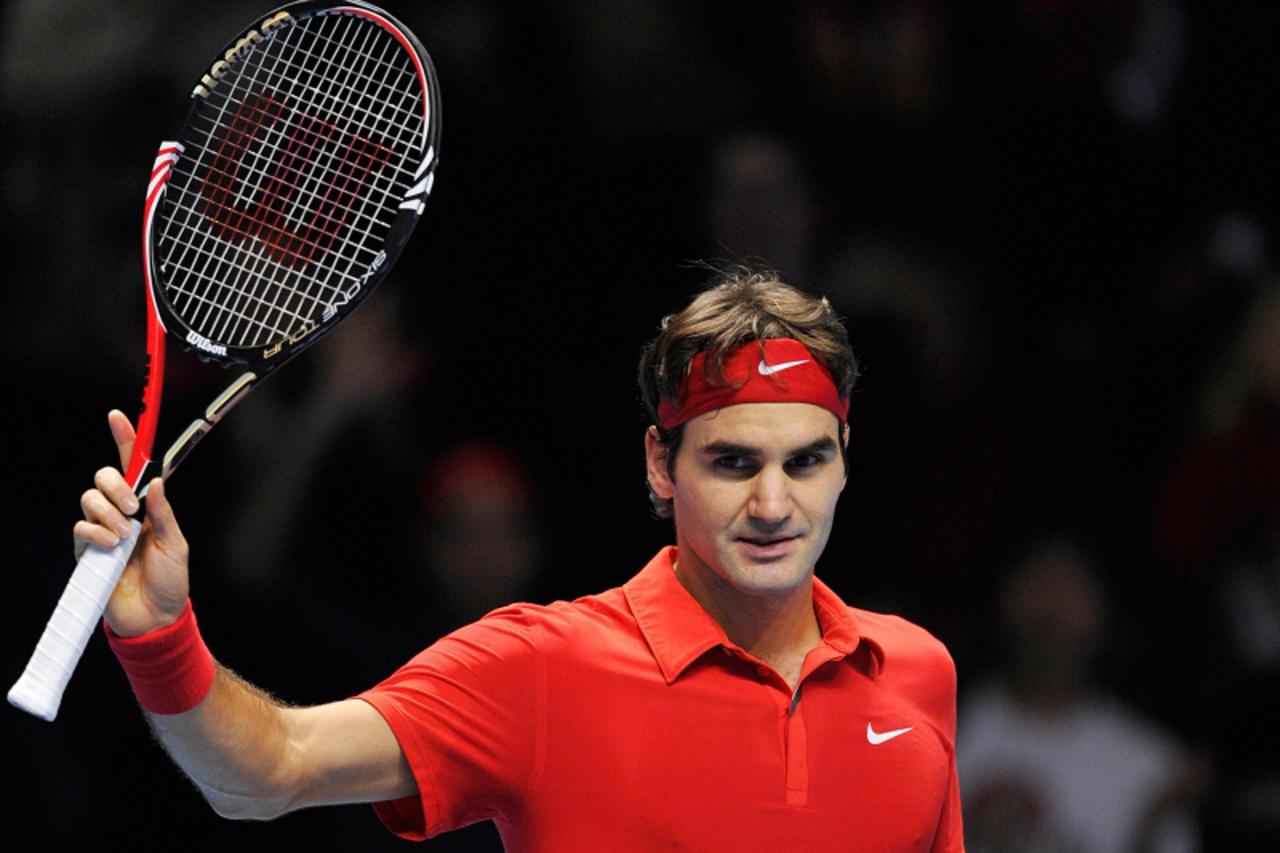 \'Switzerland\'s Roger Federer reacts after winning his singles tennis match against Great Britain\'s Andy Murray (not pictured), on the third day of the ATP World Tour Finals, at the O2, in south-eas