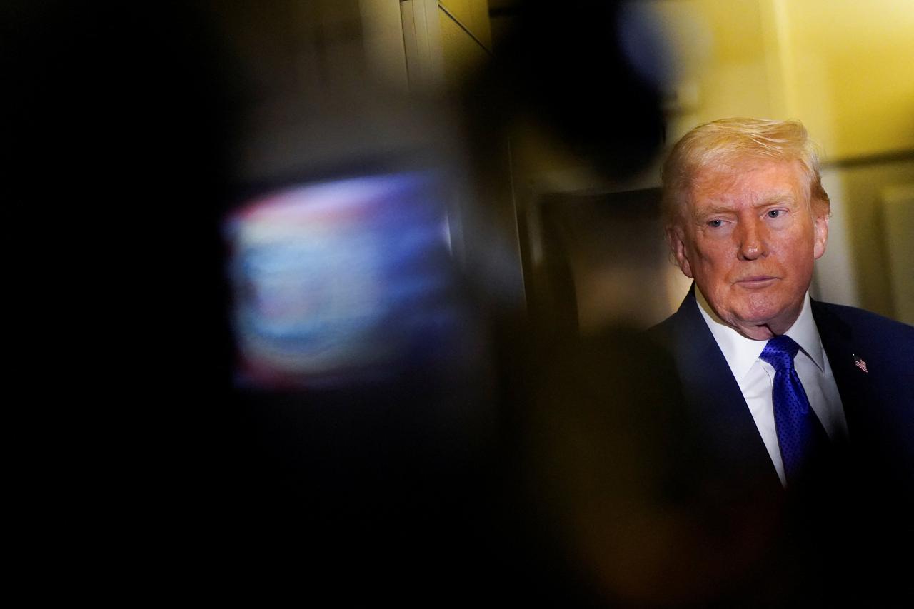 U.S. President Donald Trump speaks to reporters onboard Air Force One