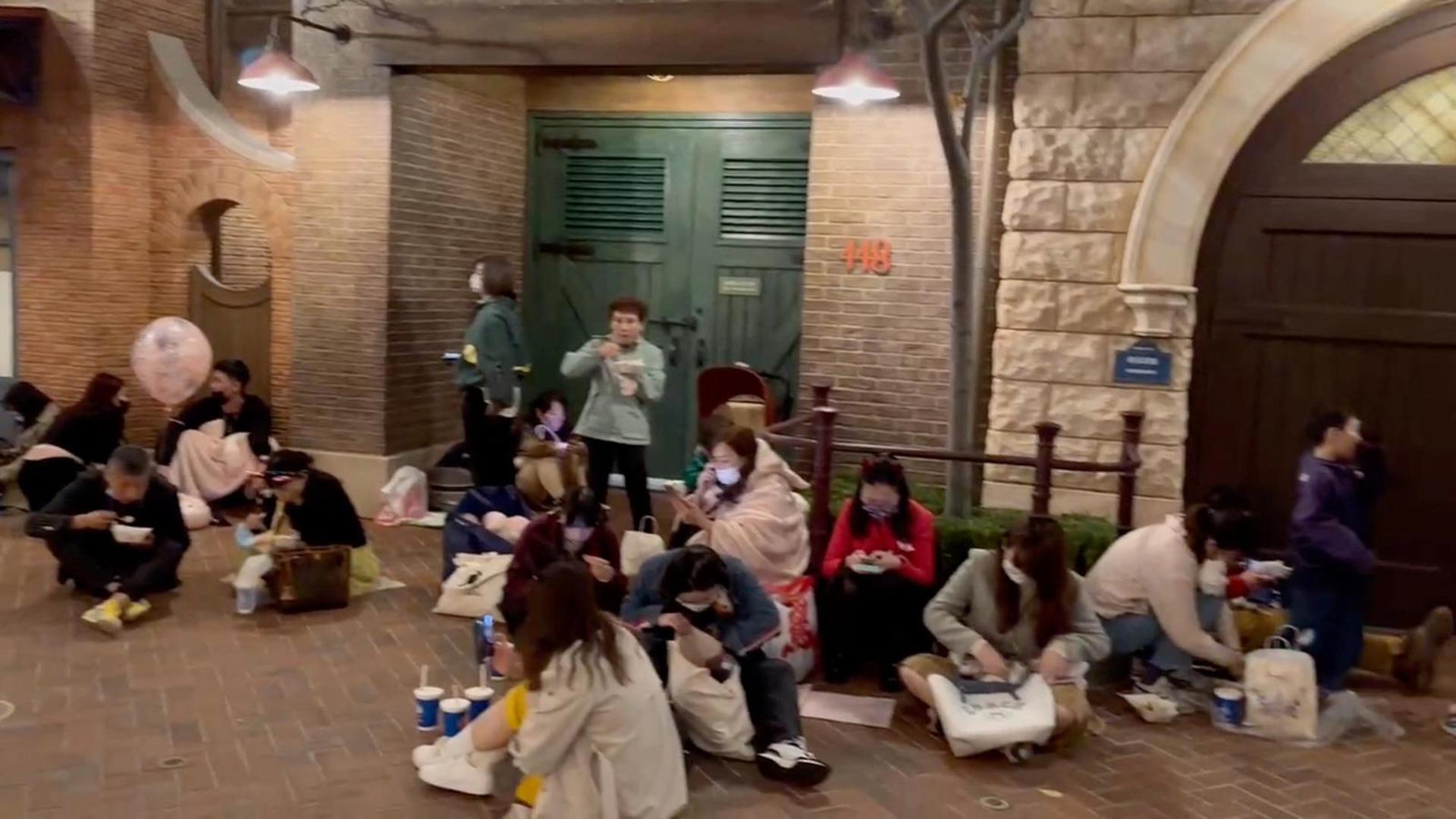 People sit inside the Shanghai Disney Resort amidst the coronavirus disease (COVID-19) outbreak, in Shanghai, China October 31, 2022 in this screen grab from a video obtained by REUTERS.  THIS IMAGE HAS BEEN SUPPLIED BY A THIRD PARTY. NO RESALES. NO ARCHIVES. Photo: SOCIAL MEDIA/REUTERS