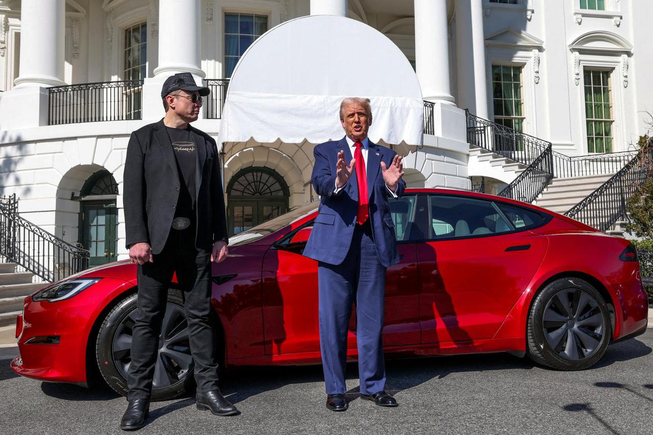 FILE PHOTO: U.S. President Donald Trump views a Tesla car at the White House in Washington