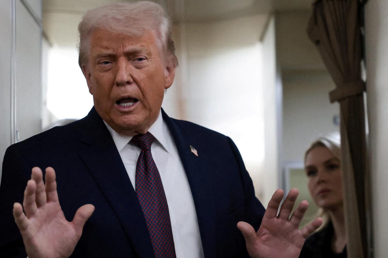 FILE PHOTO: U.S. President Donald Trump speaks to reporters aboard Air Force One