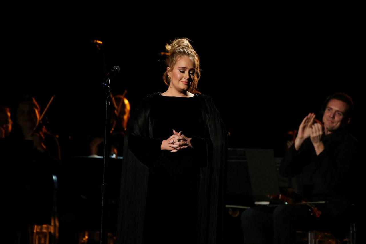 FILE PHOTO: Singer Adele is applauded as he finishes her tribute to the late George Michael at the 59th Annual Grammy Awards in Los Angeles