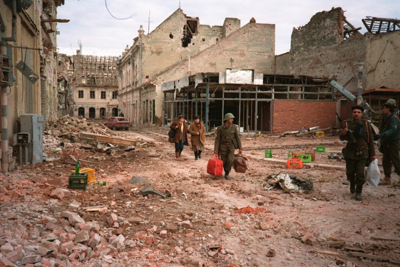 \'People leave their homes in the  destroyed town of Vukovar19 November 1991.   Having besieged the city for over three months the Federal Army finally defeated the Croatian forces leaving  ruins and 