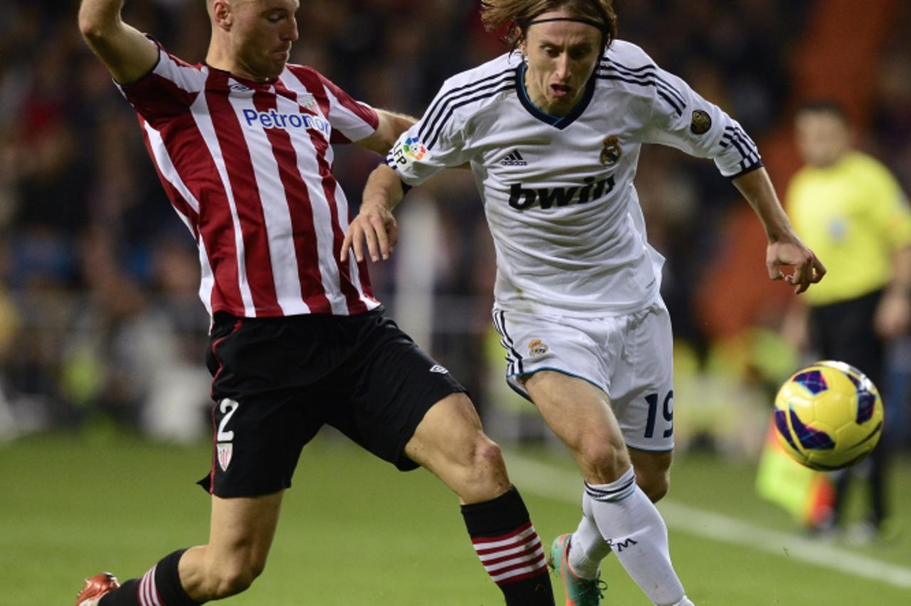 'Real Madrid\'s Croatian midfielder Luka Modric (R) vies with Athletic Bilbao\'s forward Gaizka Toquero (L) during the Spanish League football match Real Madrid vs Athletic de Bilbao at the Santiago B