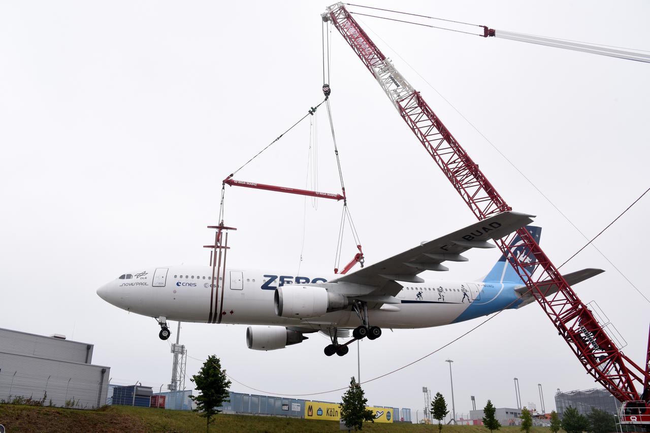 An Airbus A 300 is lifted onto a parking area using a 60-metre-high crane at Cologne/Bonn Airport, Germany, 8 August 2015. The Airbus A300 ZERO-G was used by the German Aerospace Center (DLR) as a parabolic flight aircraft to simulate zero gravity, until 