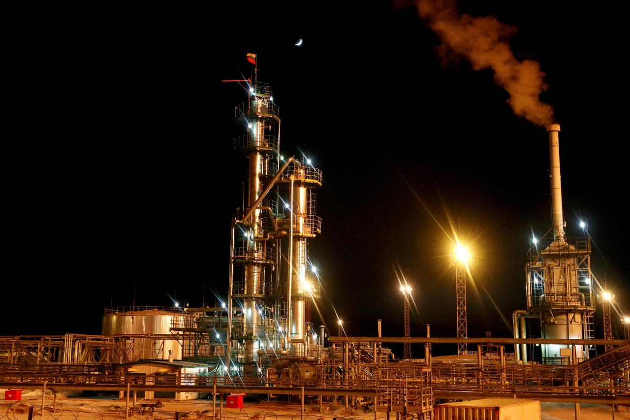 FILE PHOTO: A Russian state flag flies on the top of a diesel plant in the Irkutsk Oil Company-owned Yarakta Oil Field in Irkutsk Region