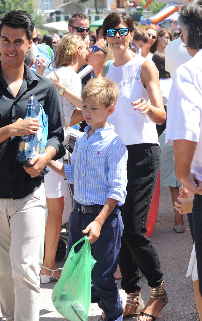 15.08.2014., Tomislavgrad - Robert i Anica Kovac s djecom na proslavi blagdana Velike Gospe u crkvi Uznesenja Blazene Djevice Marije u Seonici kod Tomislavgrada. Anica i sin Marko. PRI KORISTENJU FOTOGRAFIJE ZASTITITI IDENTITET MALOLJETNIKA! (ZAMUTITI LICE). "nPhoto: Hrvoje Jelavic/PIXSELL