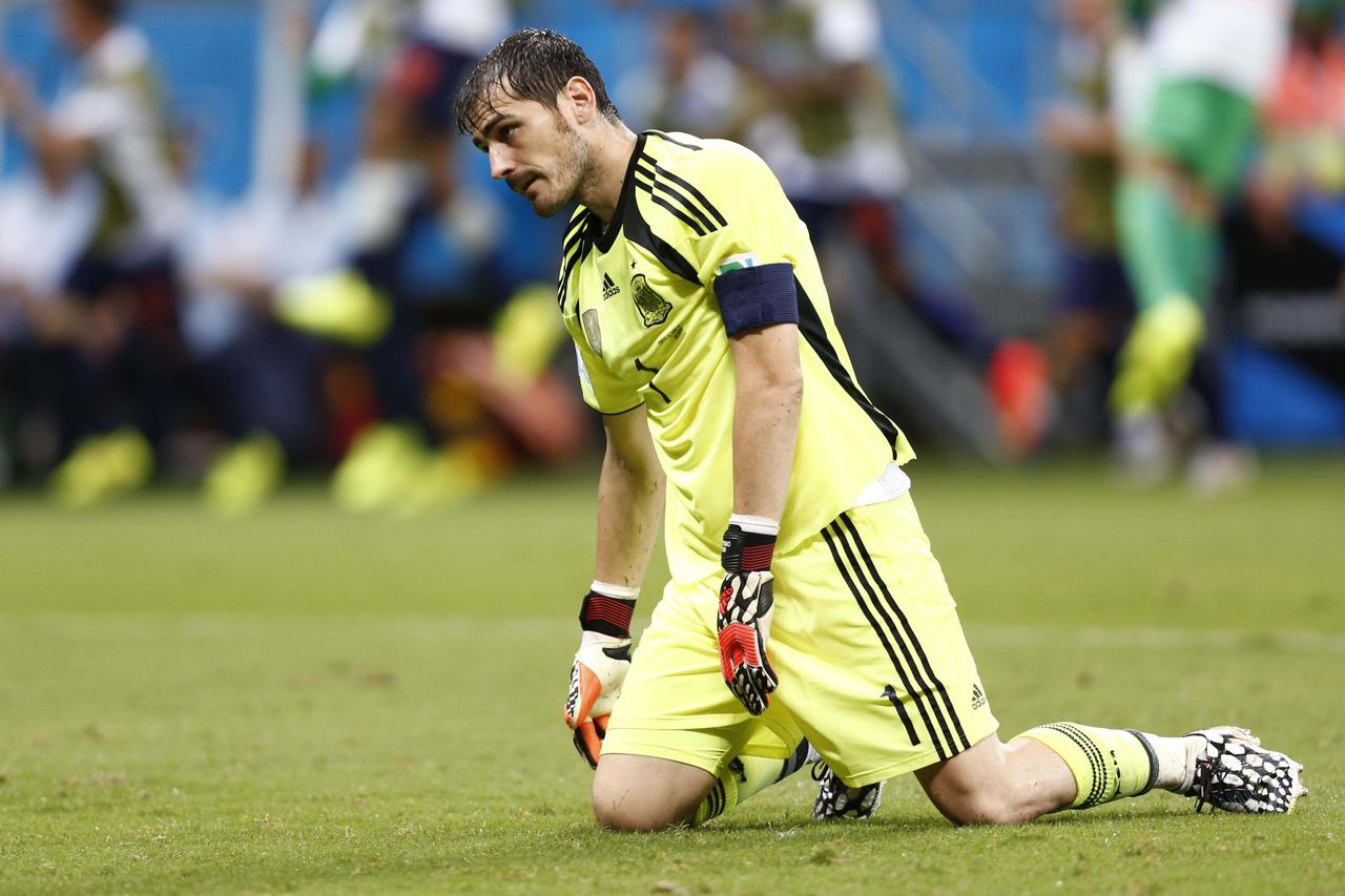 Spain's goalkeeper  Iker Casillas reacts after a goal by Netherlands during their  2014 World Cup Group B soccer match at the Fonte Nova arena in Salvador June 13,2014. REUTERS/Marcos Brindicci (BRAZIL - Tags: SPORT SOCCER WORLD CUP TPX IMAGES OF THE DAY)