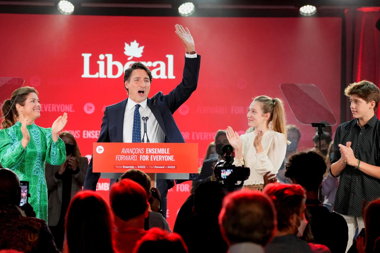 Canada's Liberal Prime Minister Justin Trudeau, accompanied by his wife Sophie Gregoire and their children Ella-Grace and Xavier, waves to supporters during the Liberal election night party in Montreal